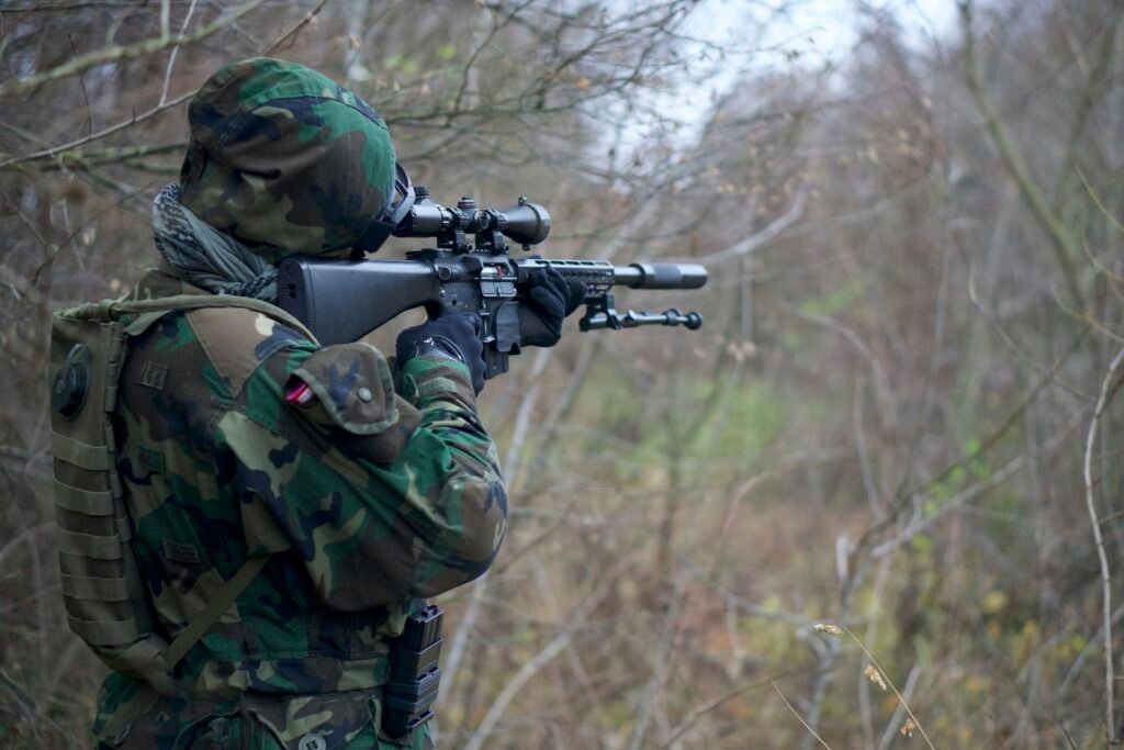 Man in Camouflage Army Uniform Holding Rifle